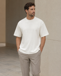 Man wearing the NORVEN Origin Heavyweight Tee in Warm White with tailored trousers